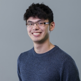 A professional headshot of a man.